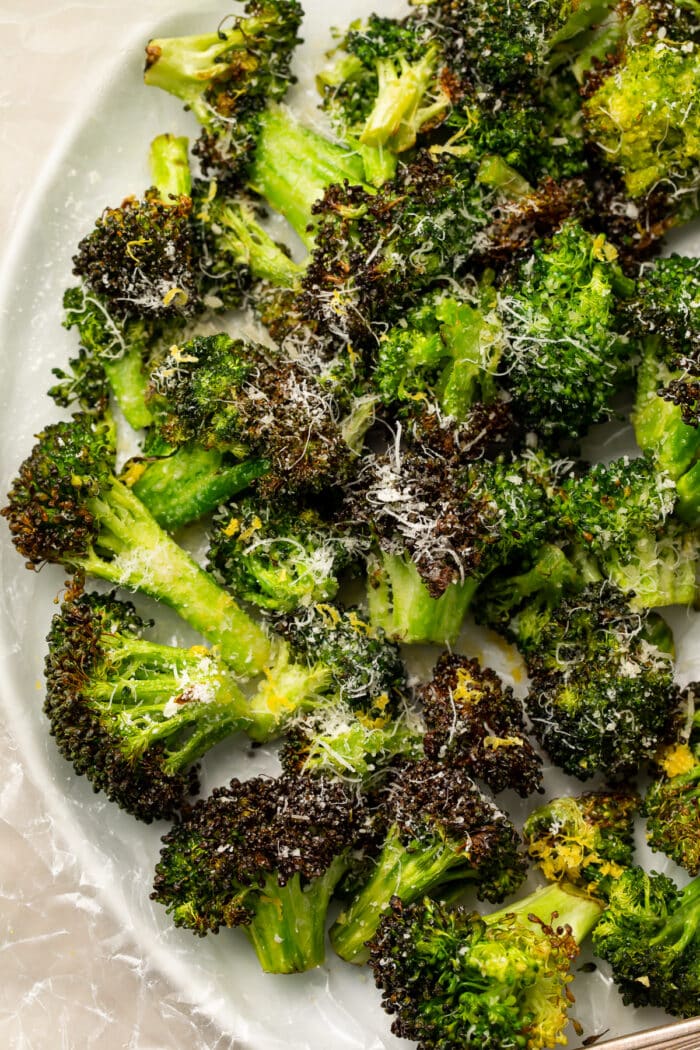 Overhead, closeup view of air fryer broccoli on a white plate