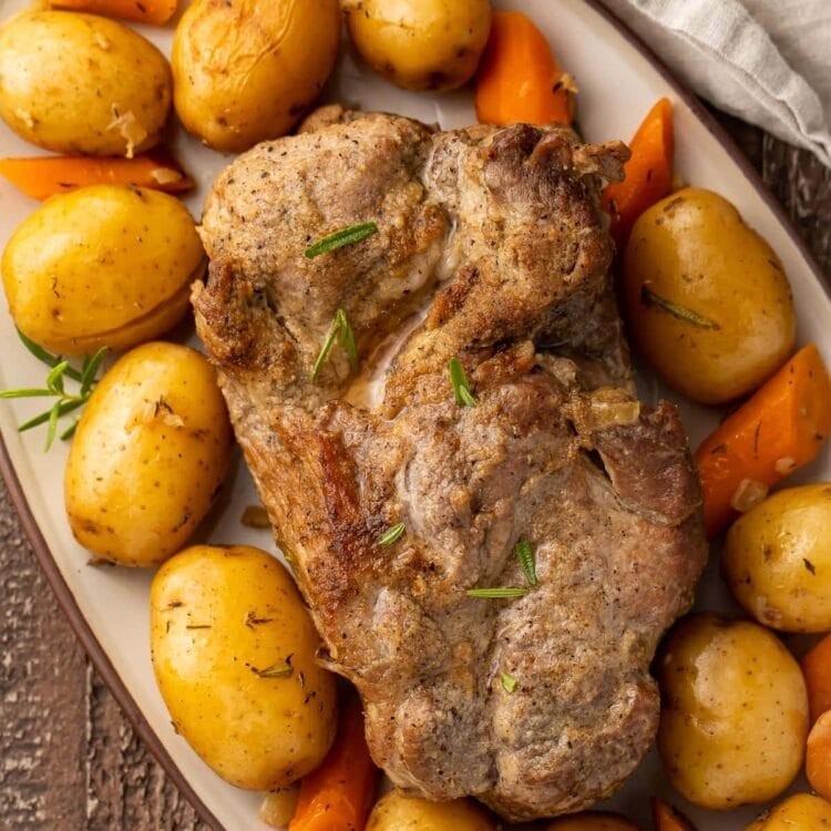 Instant Pot pork roast with carrots and potatoes on a large oval-shaped dish