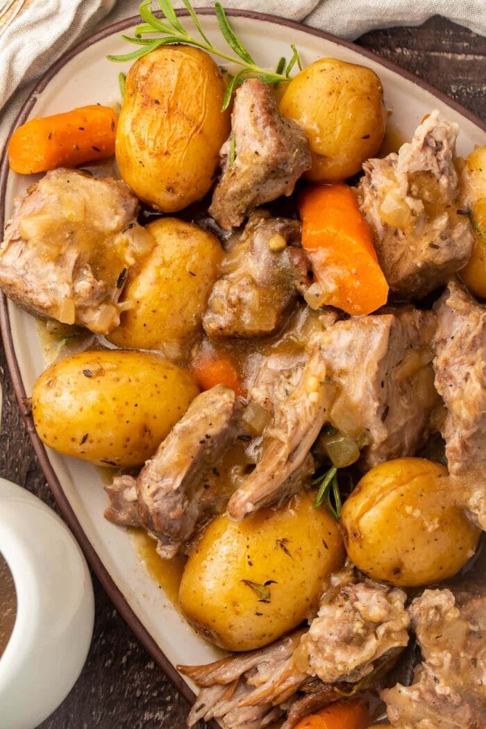 Instant Pot pork roast with carrots and potatoes on a large oval-shaped dish