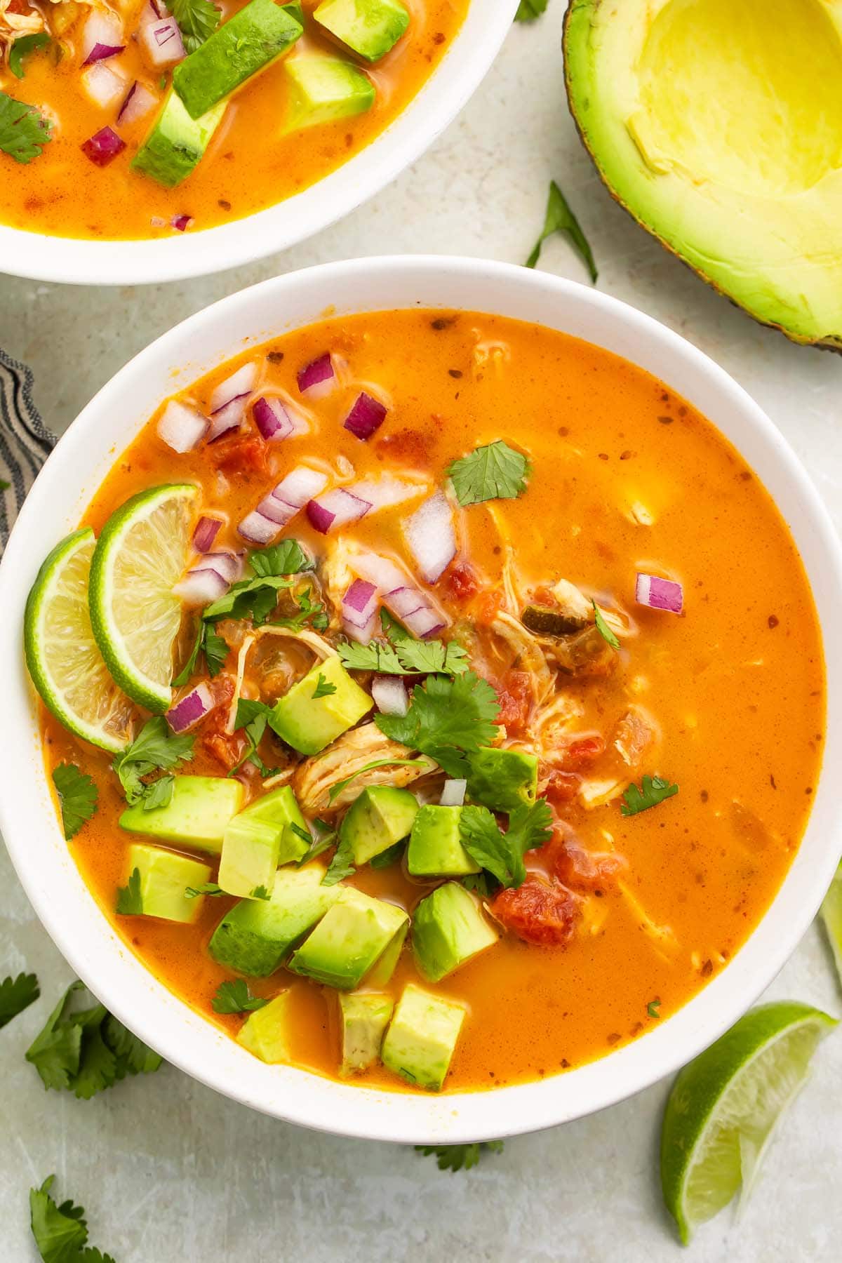A large white bowl of Whole30 chicken tortilla-less soup on a table.