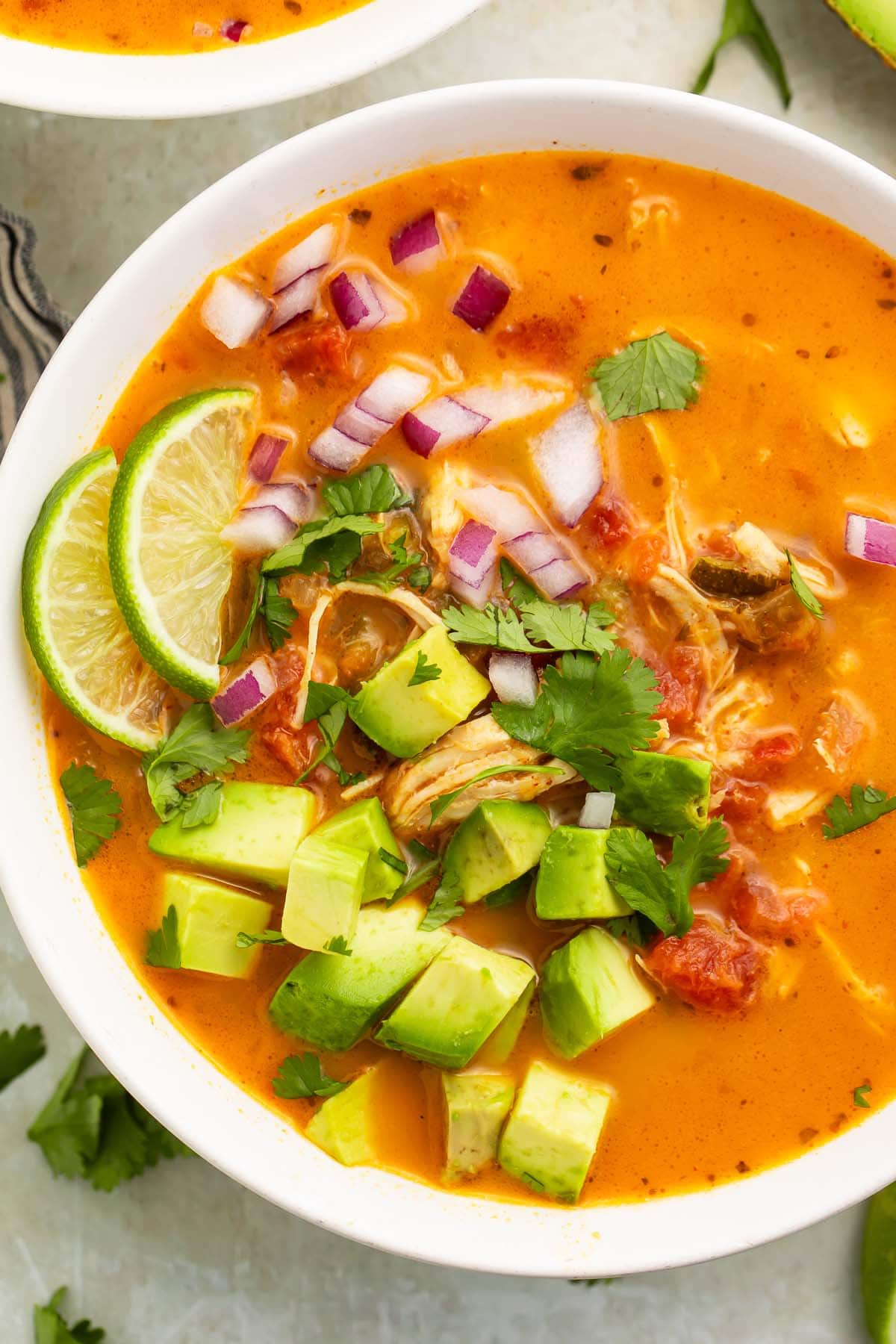 A close-up of a bowl of Whole30 chicken tortilla-less soup on a table.