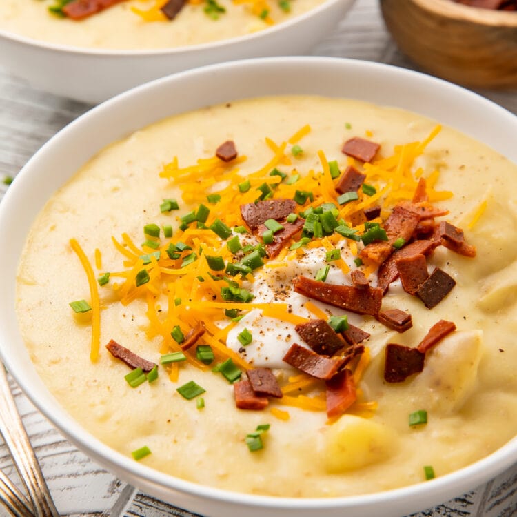 A side view of a bowl of vegan potato soup sitting on a table