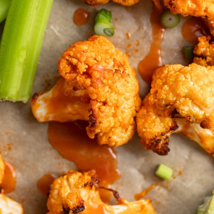 close up image of air fryer buffalo cauliflower with celery on the side