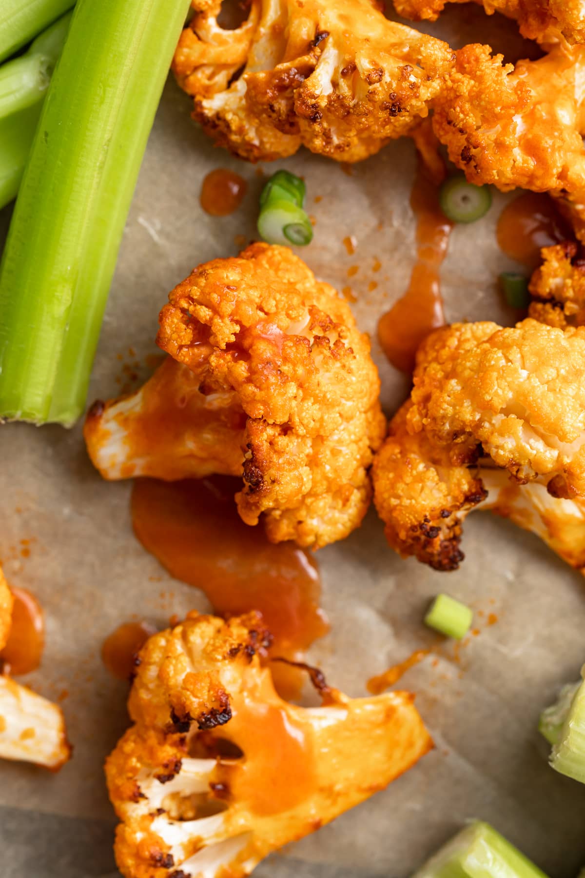 close up image of air fryer buffalo cauliflower with celery on the side