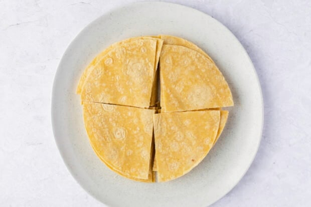 Corn tortillas quartered into tortilla chip shapes