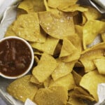 Overhead view of air fryer tortilla chips in a large bowl
