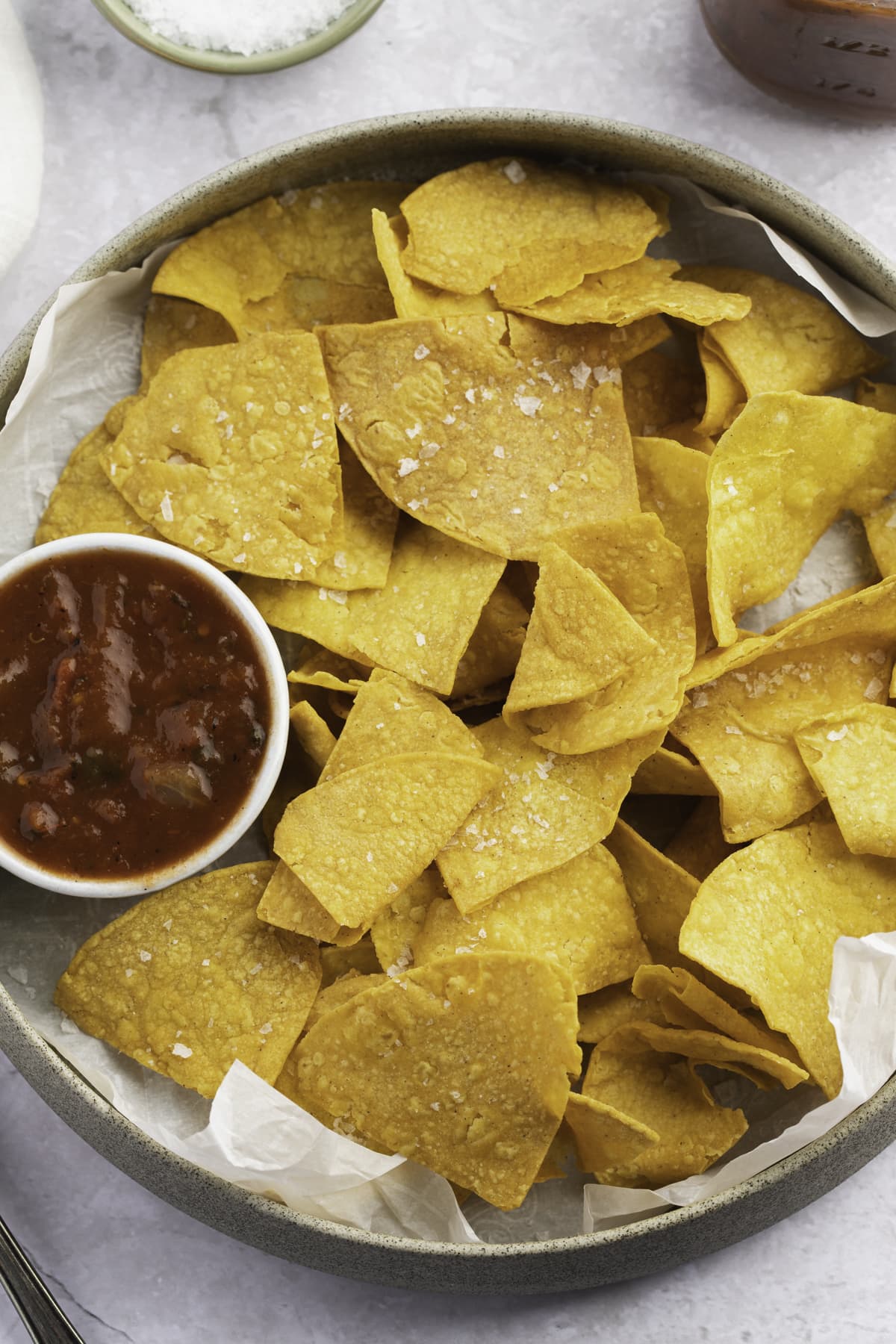 Overhead view of air fryer tortilla chips in a large bowl