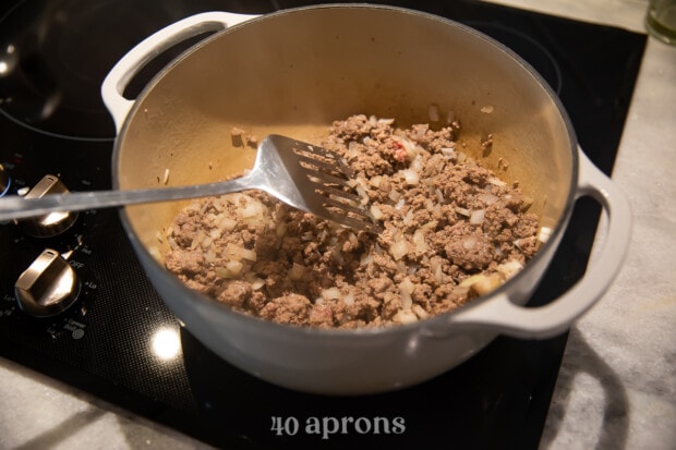 Meat and onions in medium saucepan