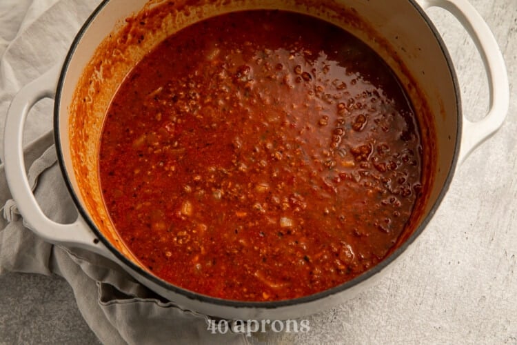 Chicken broth and tomato paste in large pot
