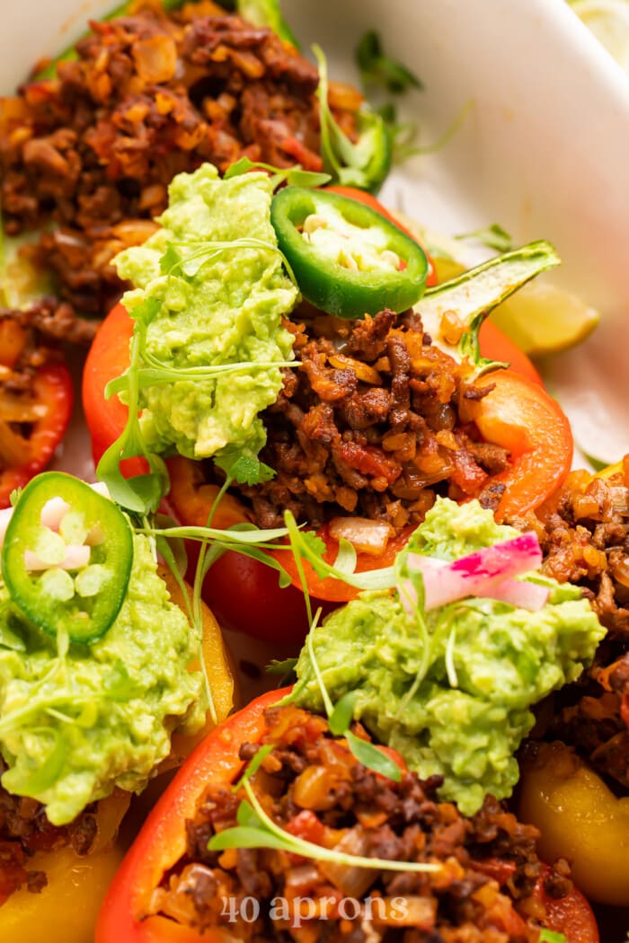 Close-up view of Whole30 taco stuffed peppers in a baking dish