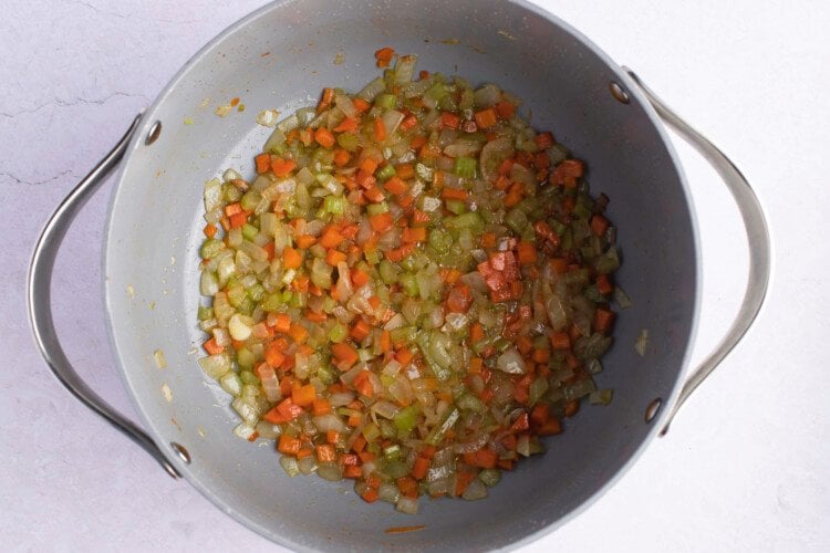 Onions, celery, and carrots in large heavy-bottomed pot with bacon drippings.