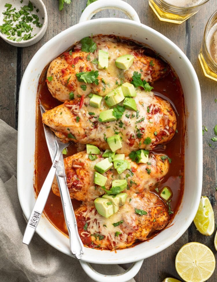overhead image of salsa chicken in a baking dish with cilantro and avocado on top