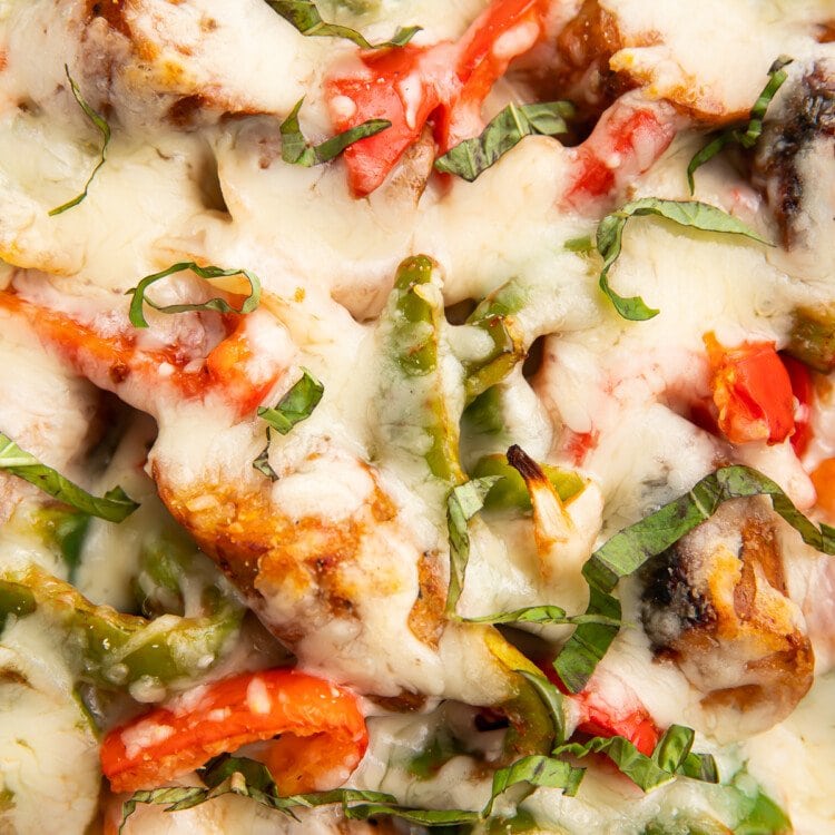 Extreme close-up view of the top of the cheesy Italian sausage and bell pepper casserole.