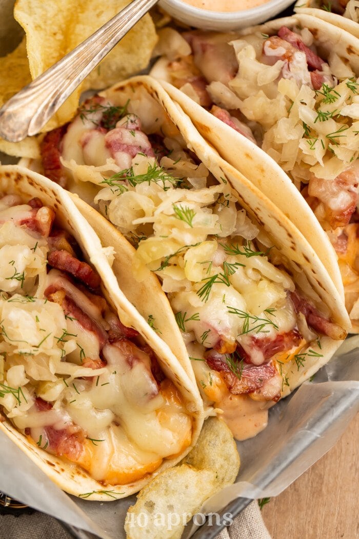 Overhead closeup view of 3 reuben tacos side-by-side