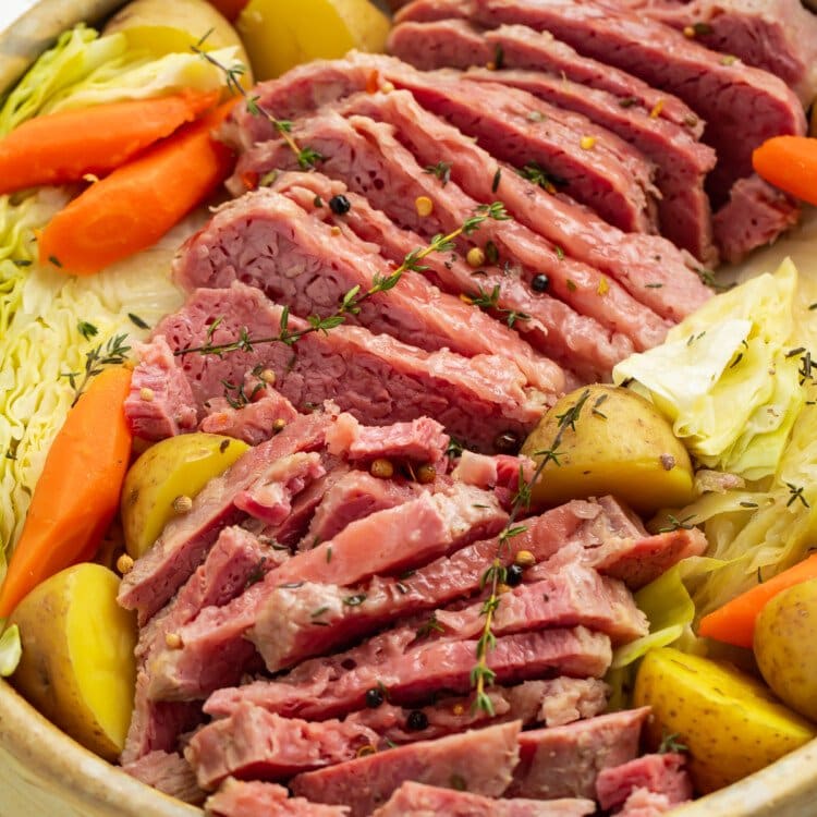 Overhead angled view of a large bowl of corned beef, cabbage, potatoes, and carrots