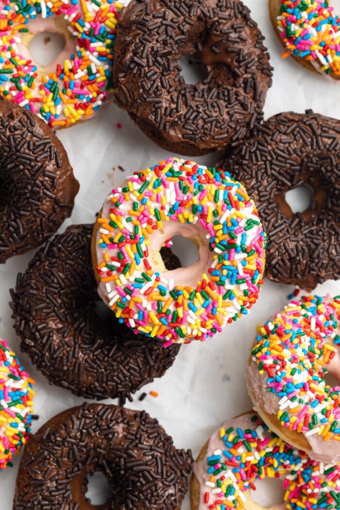 Overhead view of chocolate and vanilla gluten-free donuts with sprinkles.
