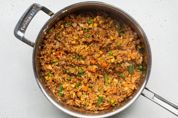 Overhead view of vegetable fried rice in a large skillet.
