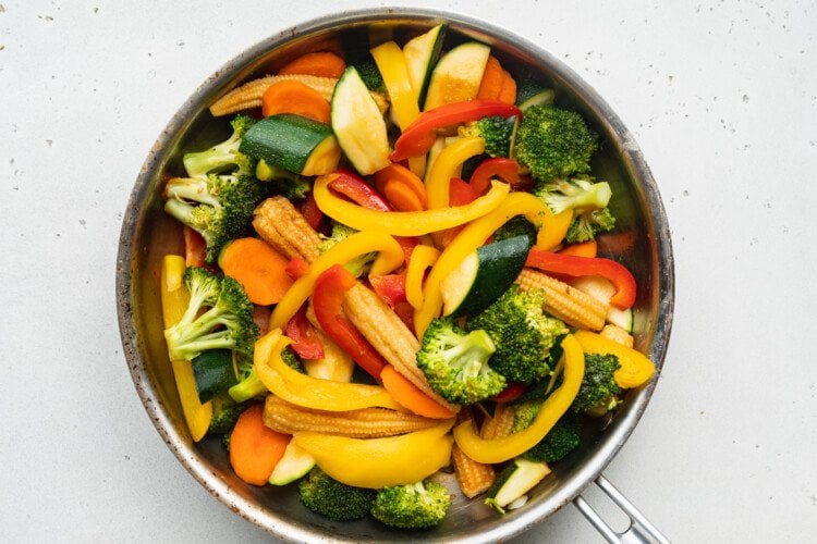 Overhead view of sautéed hibachi vegetables in a large skillet.