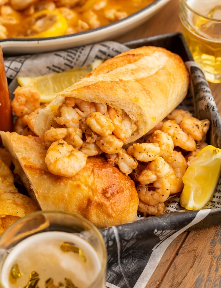 BBQ shrimp po-boys arranged on a pan with delicious buttery shrimp surrounding them.