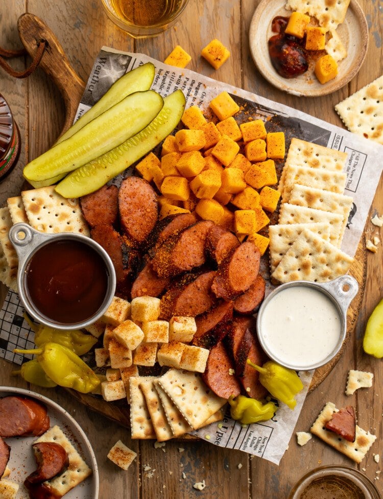 Overhead view of a Memphis-style cheese and sausage plate with pickles and crackers.