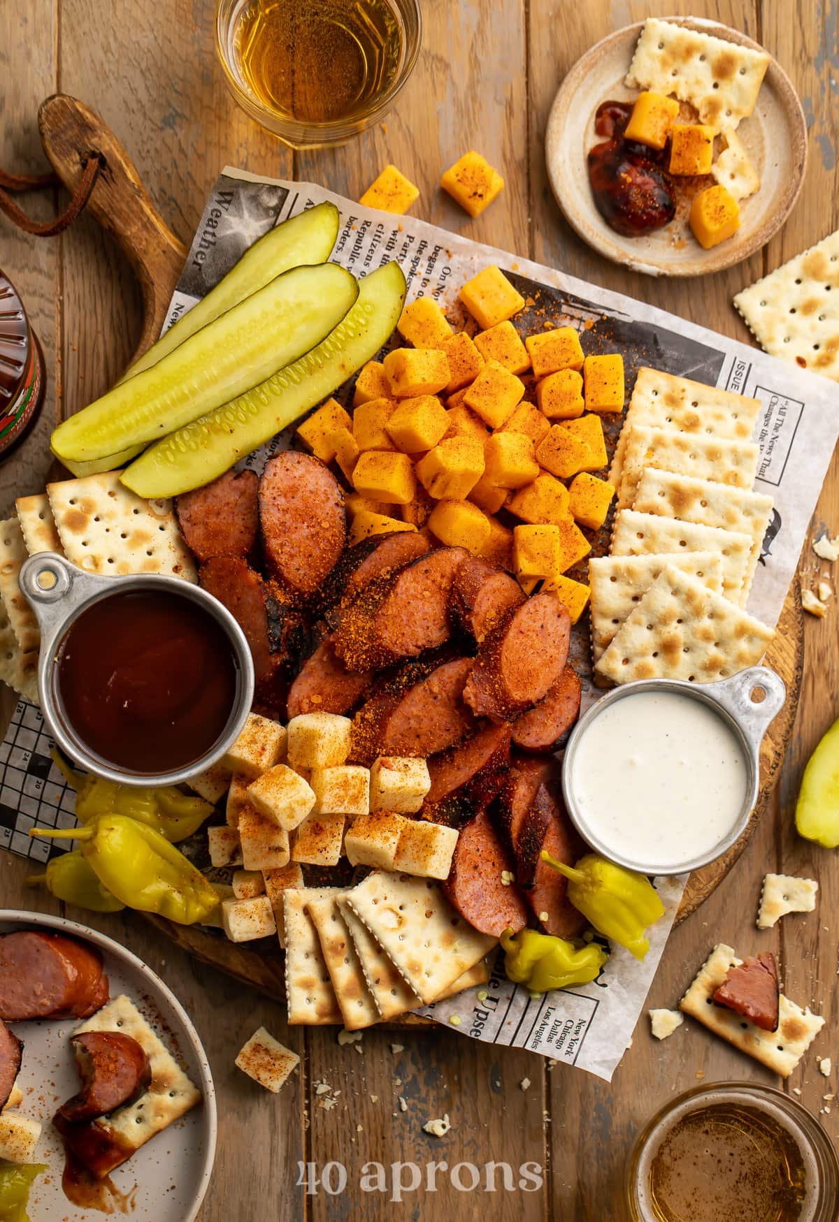 Overhead view of a Memphis-style cheese and sausage plate with pickles and crackers.