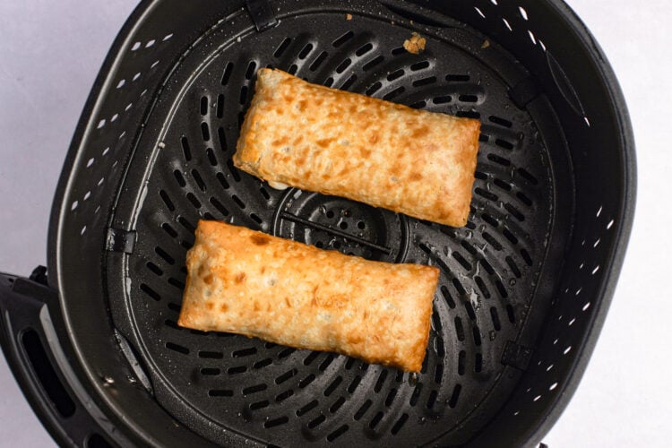 Overhead view of cooked frozen hot pockets in air fryer basket.