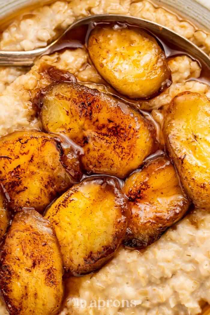 Close-up of maple syrup caramelized bananas on top of a bed of oatmeal.