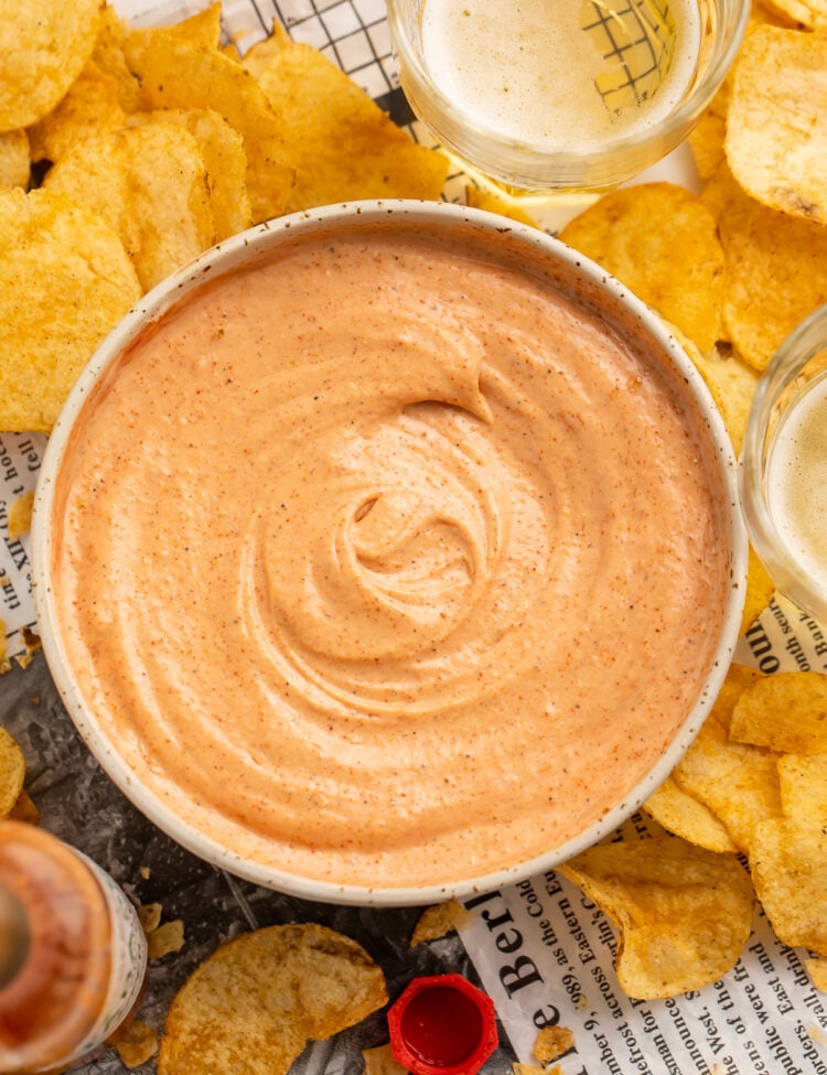 Overhead view of a bowl of cajun sauce surrounded by Zapp's potato chips.