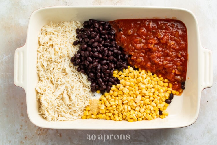 Ingredients for Mexican chicken casserole in rectangular white casserole dish.