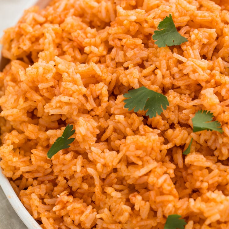 Overhead, close-up view of Instant Pot Mexican rice garnished with chopped fresh cilantro in a large white bowl.