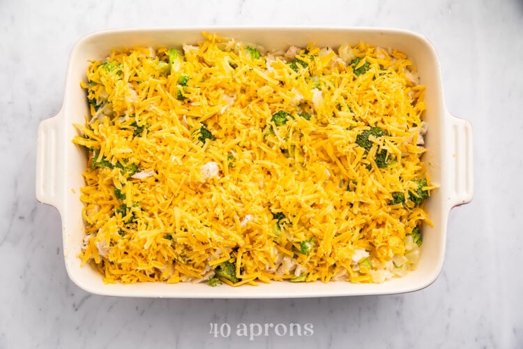 Overhead view of cheesy chicken, broccoli, rice casserole in a large white rectangular casserole dish.