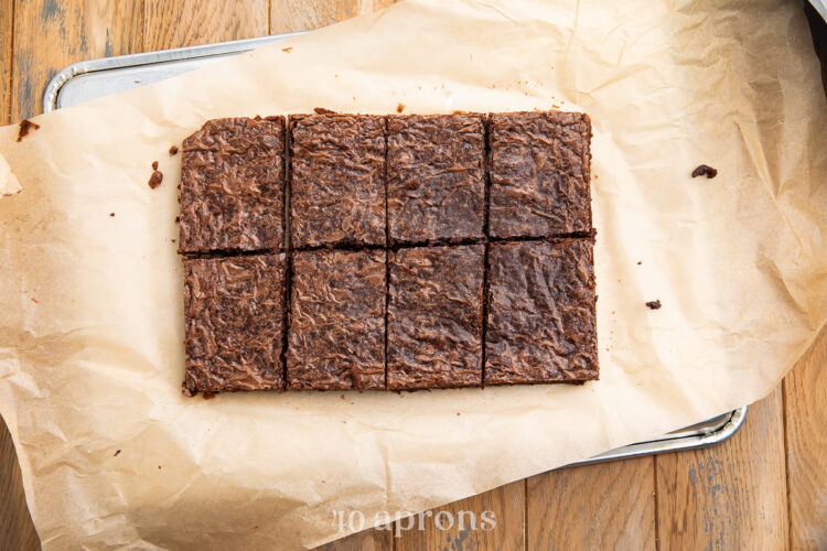Overhead view of a sheet of chocolate brownies, cut into 8 rectangles before being decorated.