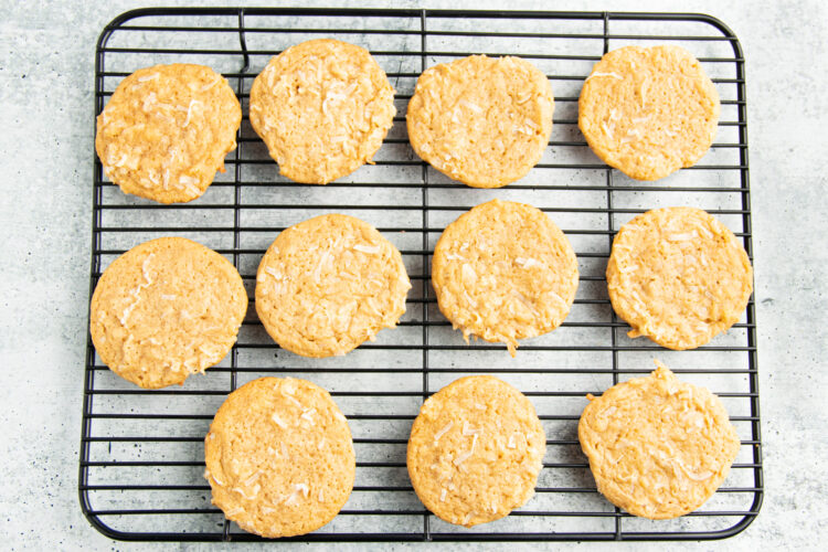Overhead view of coconut cookies on a wire cooling rack.