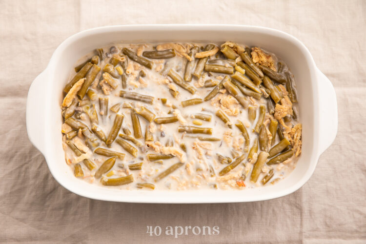 Overhead view of an unbaked make ahead green bean casserole in a large casserole dish.