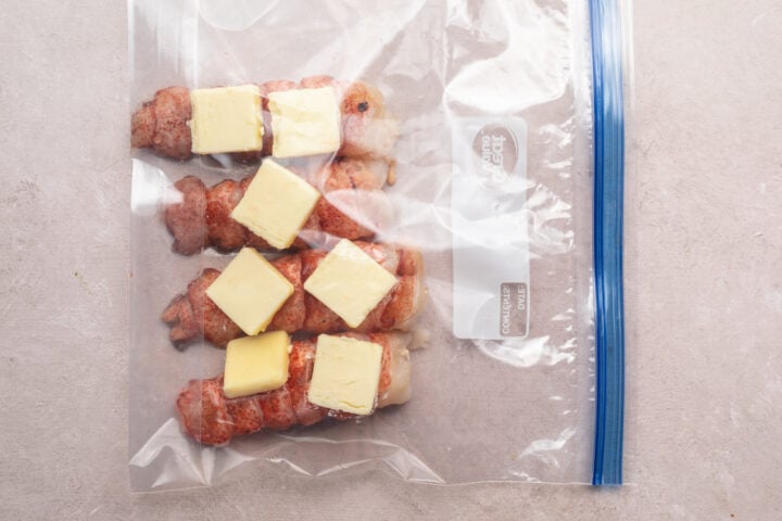 Lobster tails with pats of butter in sealable plastic bag.