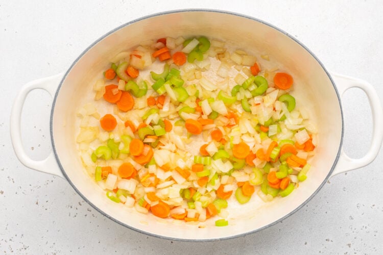 Softened onions, celery, and carrots in a large oval soup pot.