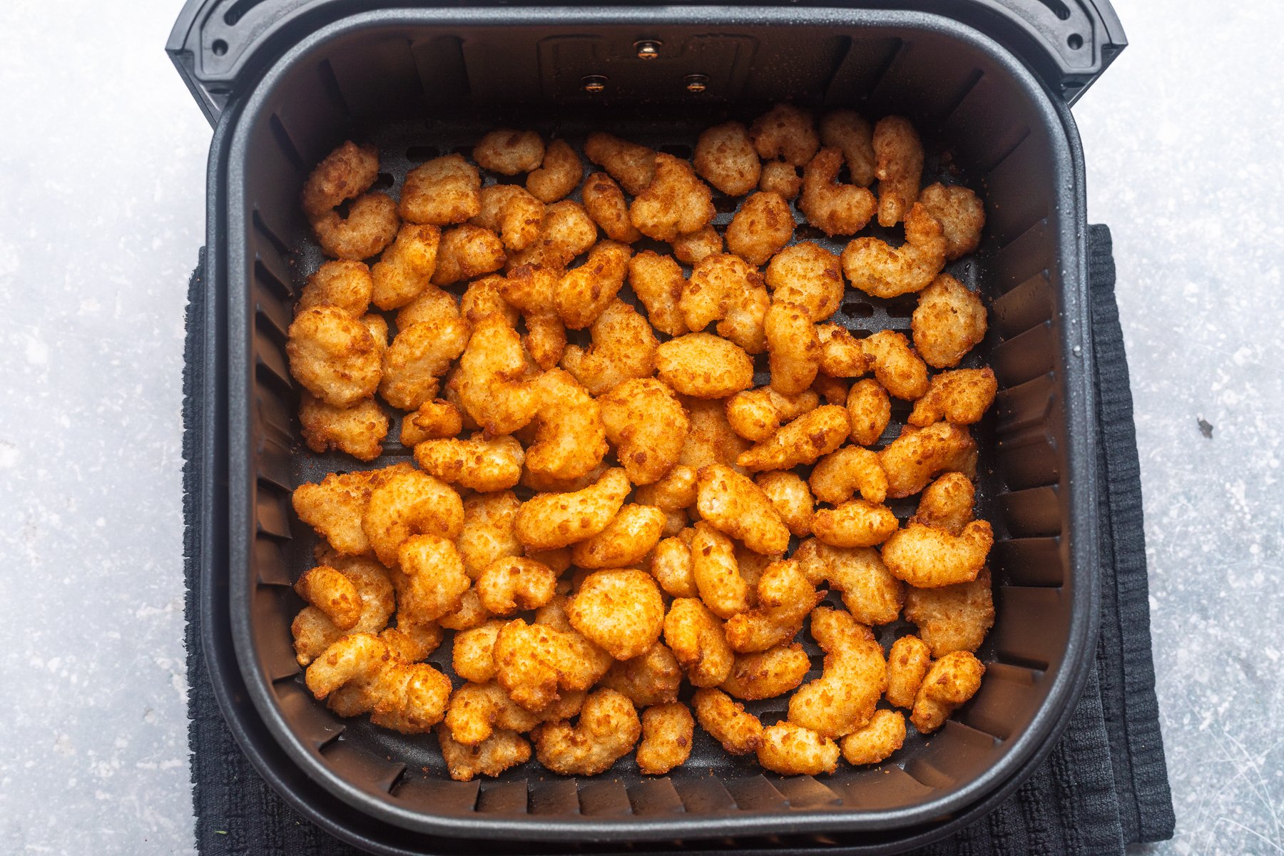 Frozen popcorn shrimp in air outlet fryer