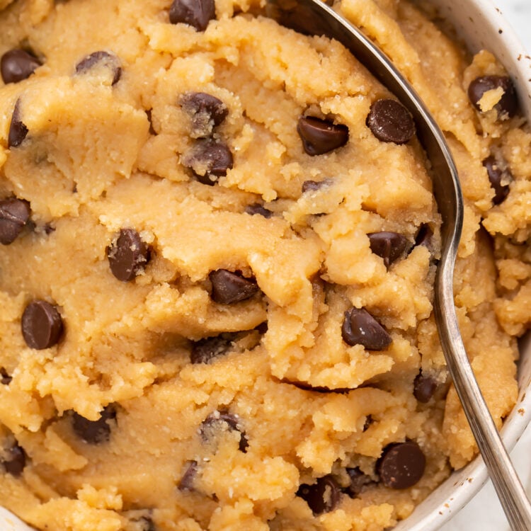 Overhead view of keto cookie dough in a large bowl with a large spoon.