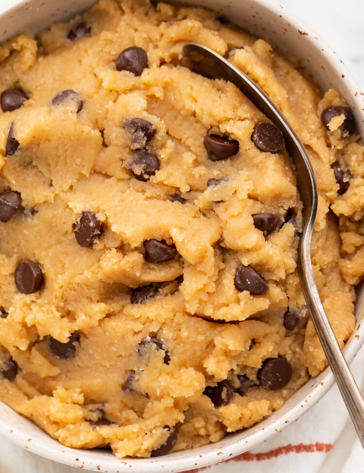 Overhead view of keto cookie dough in a large bowl with a large spoon.