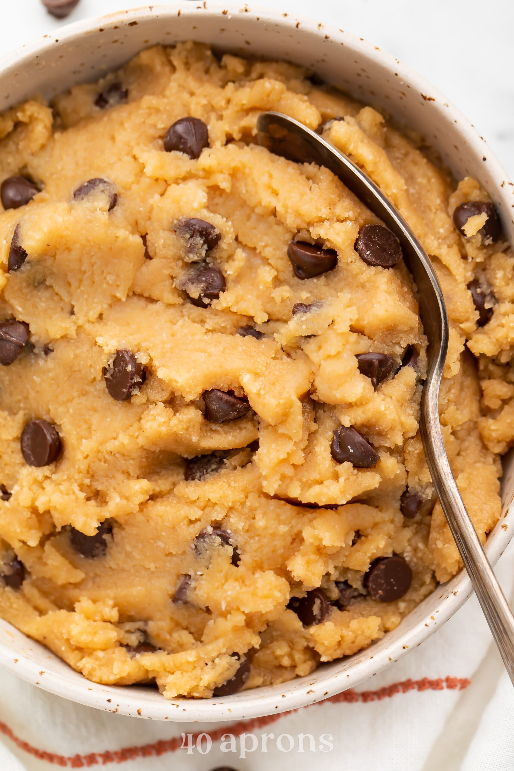 Overhead view of keto cookie dough in a large bowl with a large spoon.