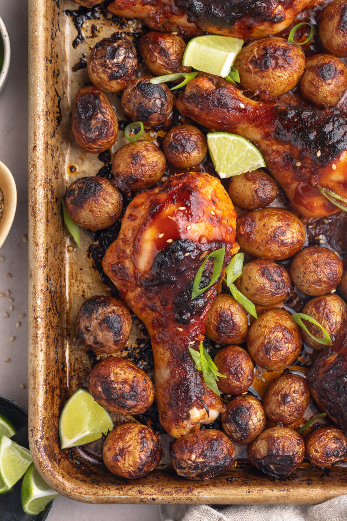 Top-down look at Gochujang chicken with potatoes on a sheet pan after oven-roasting.
