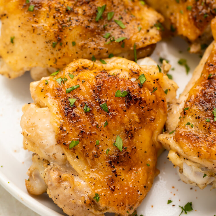 Overhead look at crispy, perfect Instant Pot chicken thighs on a plate.