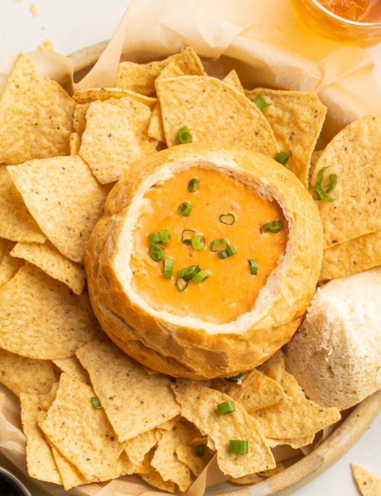 Top-down view of McAlister's chicken tortilla soup copycat in a bread bowl surrounded by tortilla chips.