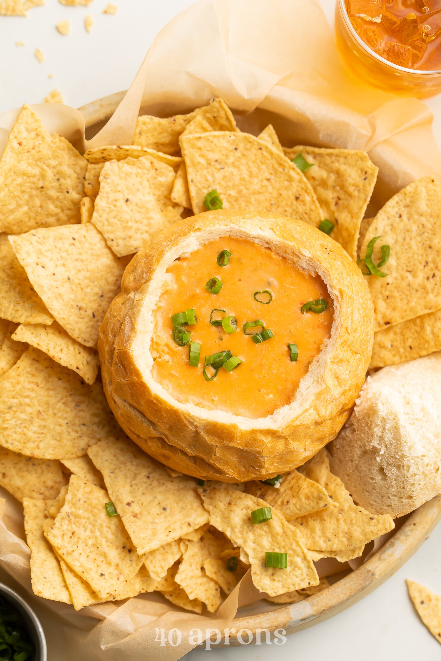 Top-down view of McAlister's chicken tortilla soup copycat in a bread bowl surrounded by tortilla chips.