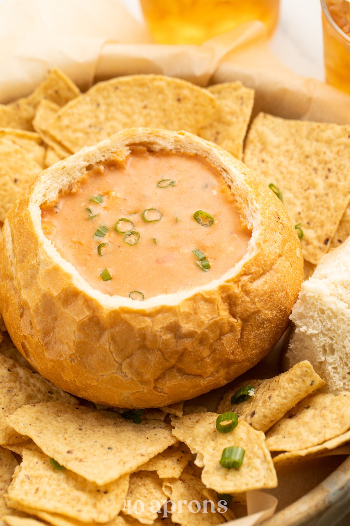 A bread bowl holding a copycat version of McAlister’s Chicken Tortilla Soup surrounded by tortilla chips.