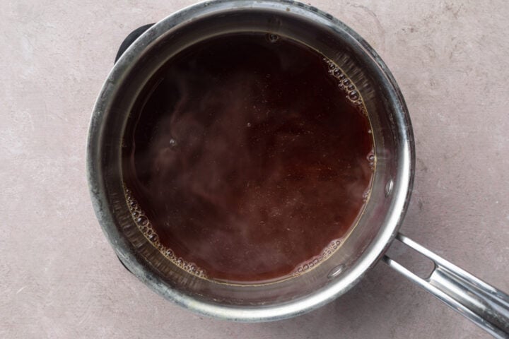 Tempura sauce in a small silver saucepan.