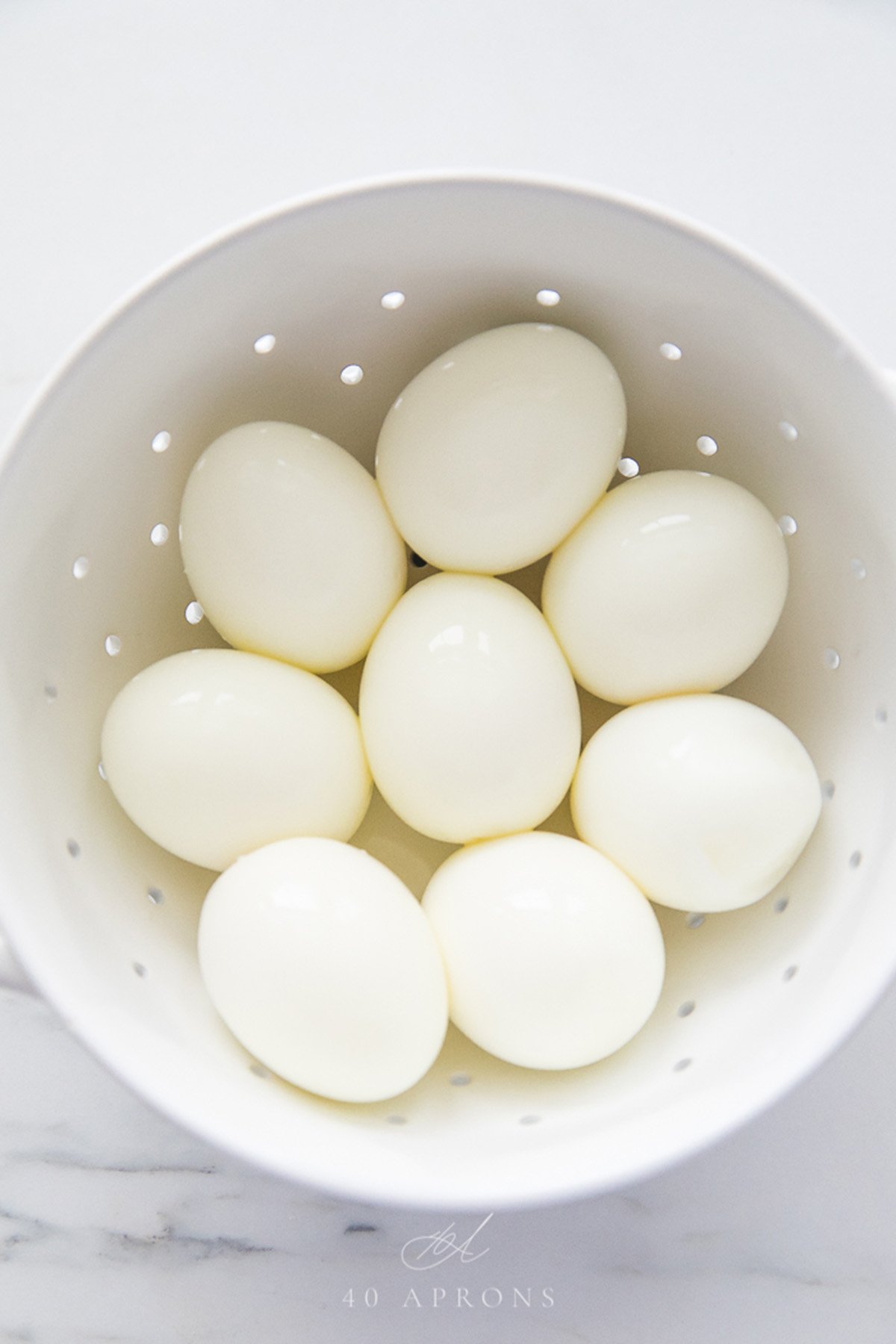 A bowl of perfect peeled soft and hard boiled eggs.