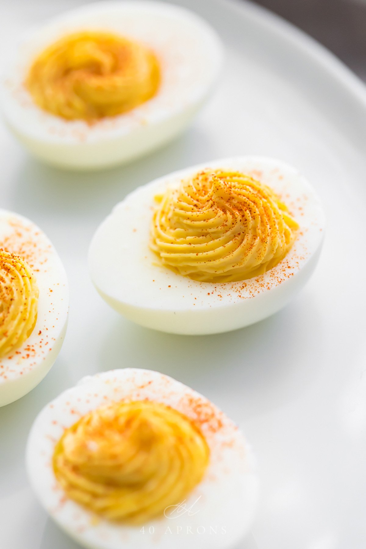 Up close of perfect deviled eggs with yolks piped into center.