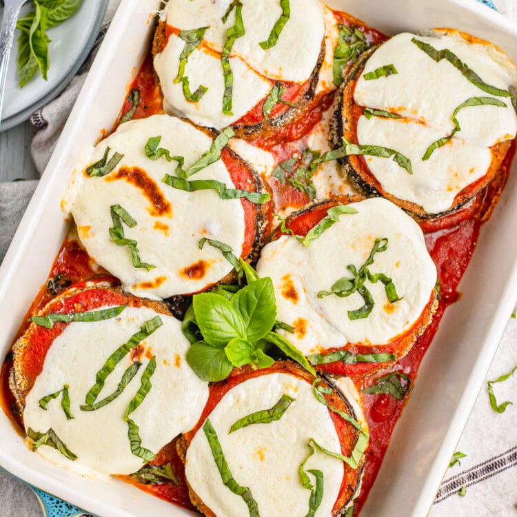 Keto eggplant parmesan in a deep baking dish with turquoise handles.
