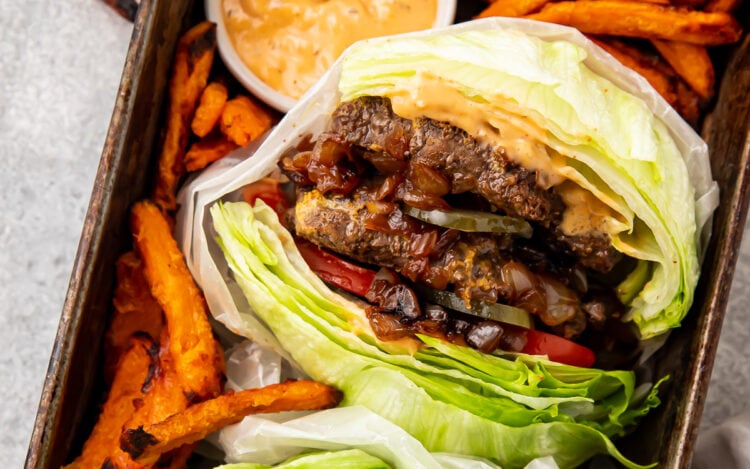 Image for a lettuce wrapped burger joint style burger with sweet potato fries.